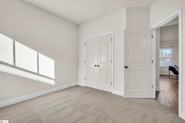 unfurnished bedroom featuring carpet floors and a closet