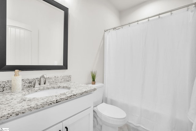 full bathroom with vanity, shower / bath combo, and toilet