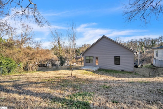 view of property exterior featuring a lawn and a patio area