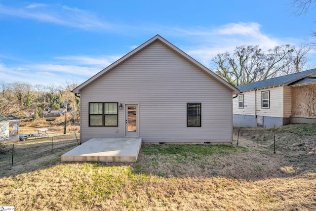 back of property featuring a lawn and a patio