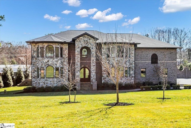 french country inspired facade featuring a front lawn