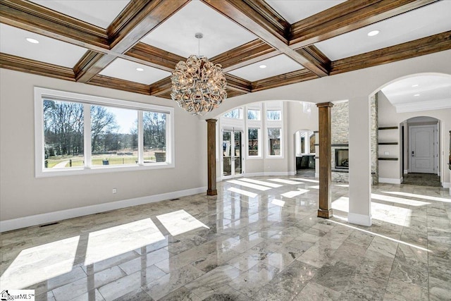 unfurnished living room featuring coffered ceiling, beamed ceiling, and ornate columns