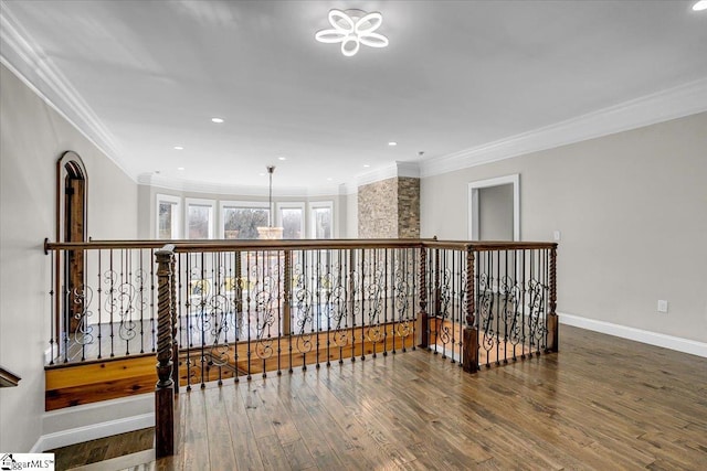 hallway with hardwood / wood-style flooring and ornamental molding