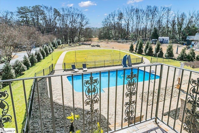 view of pool featuring a yard and a patio area