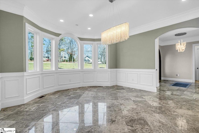 unfurnished dining area with crown molding and a notable chandelier