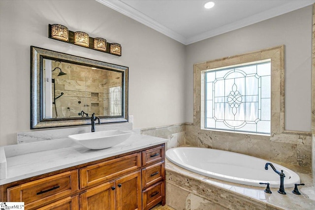 bathroom featuring tiled tub, crown molding, and vanity