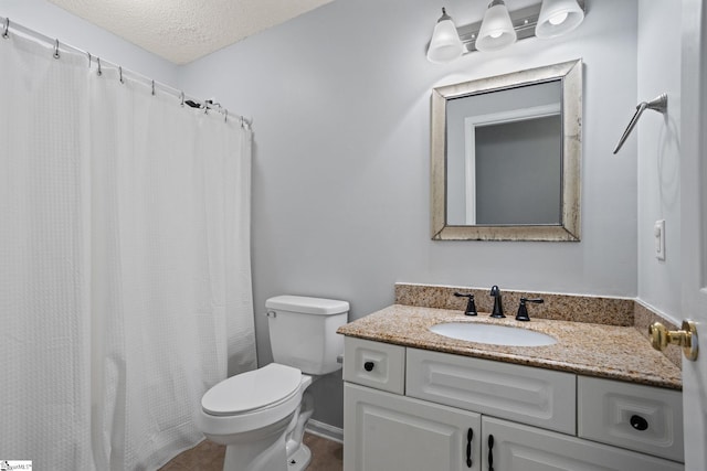 bathroom with vanity, toilet, a shower with shower curtain, and a textured ceiling