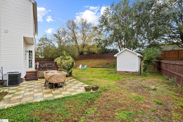 view of yard with cooling unit, a storage unit, a deck, and a patio