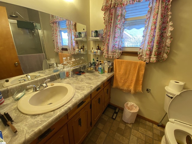 bathroom with vanity, plenty of natural light, and toilet