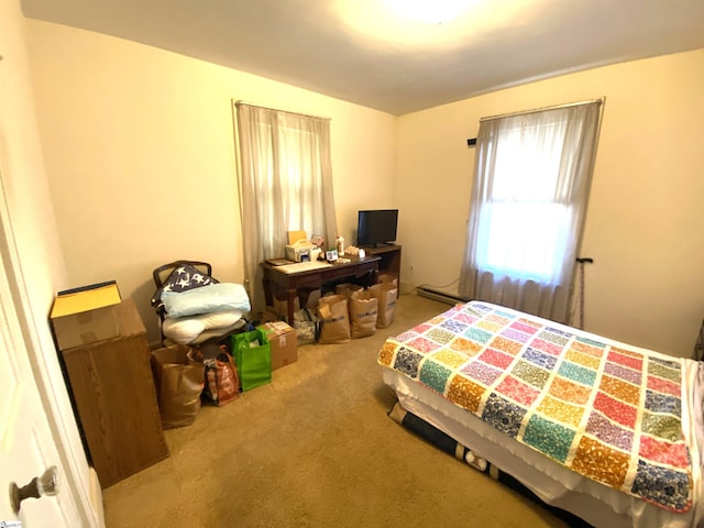 carpeted bedroom with baseboard heating