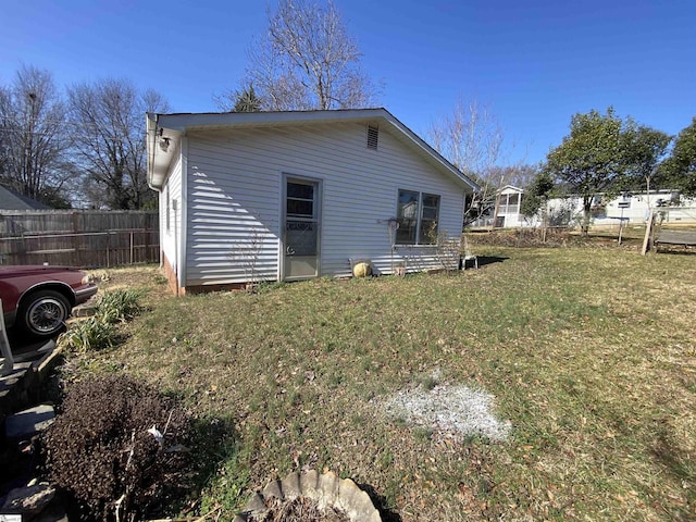 back of property featuring a yard