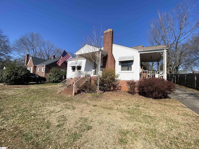 back of property featuring a porch and a yard