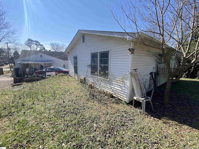 view of property exterior featuring a lawn