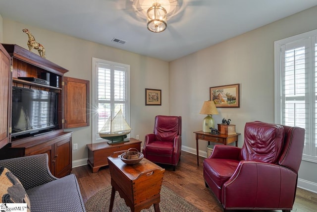 sitting room with dark hardwood / wood-style flooring