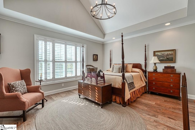 bedroom featuring an inviting chandelier, hardwood / wood-style floors, crown molding, and high vaulted ceiling