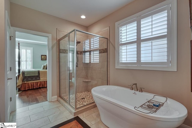 bathroom featuring tile patterned flooring and separate shower and tub