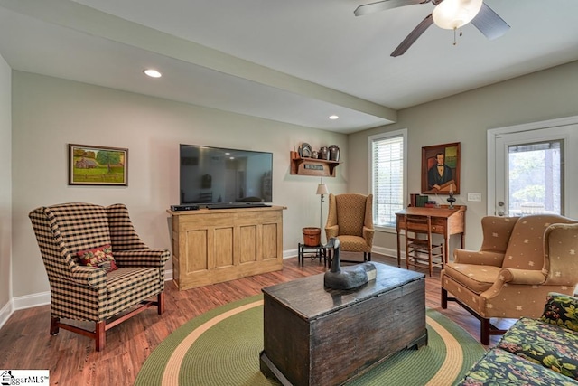 living room featuring hardwood / wood-style flooring and ceiling fan