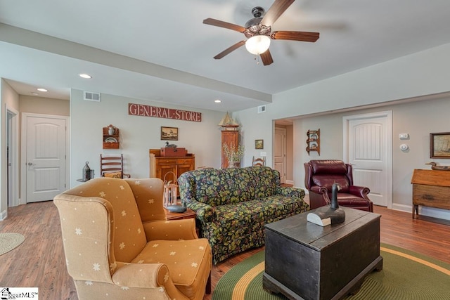 living room with hardwood / wood-style floors and ceiling fan