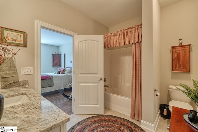 bathroom with lofted ceiling, tile patterned floors, shower / bathtub combination with curtain, and vanity