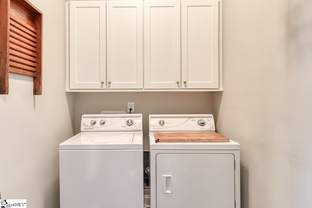 laundry room with cabinets and separate washer and dryer