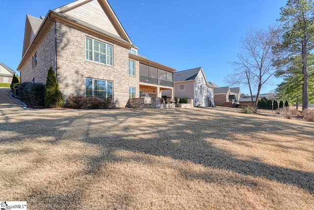 back of property with a sunroom