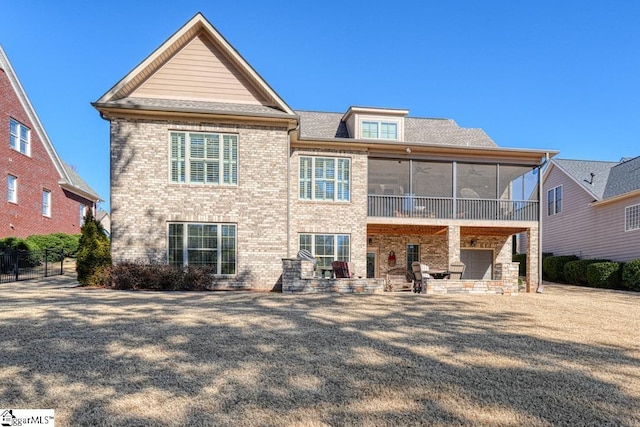 back of house with a sunroom and a patio