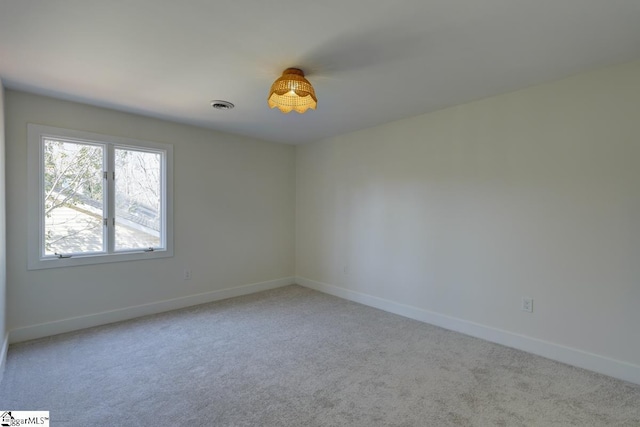 unfurnished room featuring light colored carpet