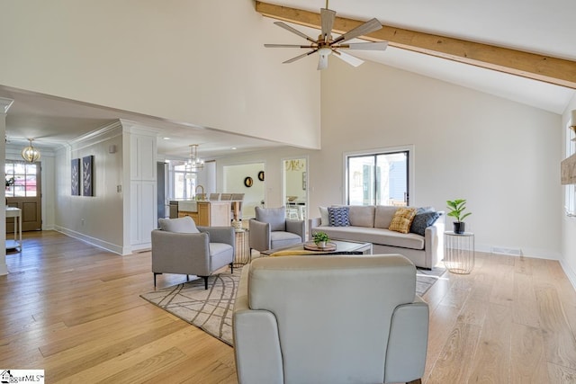 living room featuring beamed ceiling, high vaulted ceiling, ceiling fan with notable chandelier, and light hardwood / wood-style floors