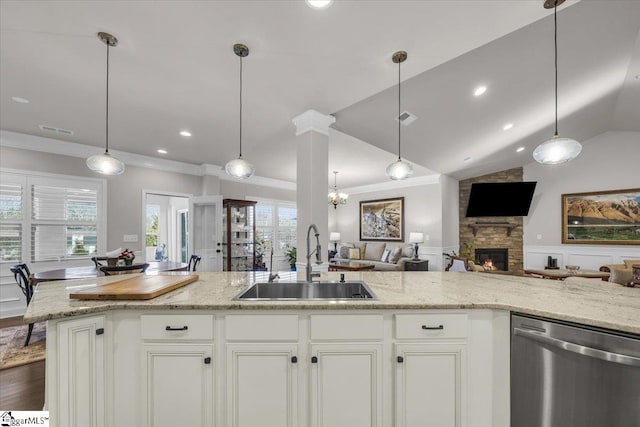 kitchen featuring dishwasher, light stone countertops, sink, and white cabinets