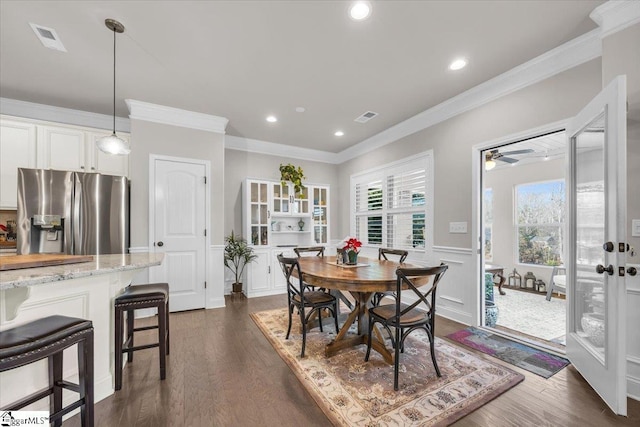 dining space featuring ornamental molding and dark hardwood / wood-style floors