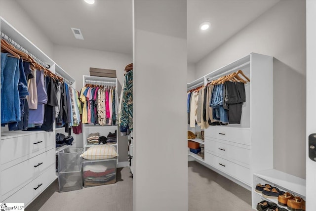 spacious closet featuring light carpet