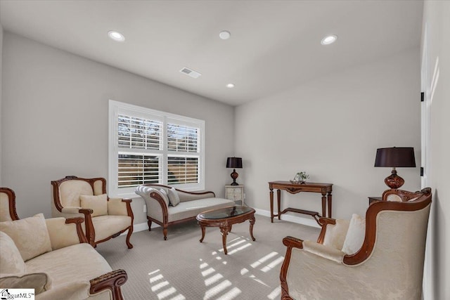 living area with light colored carpet