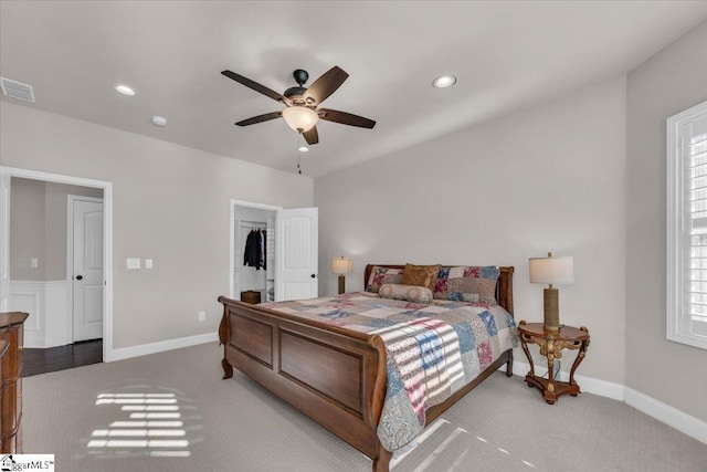 bedroom with ceiling fan, carpet flooring, and multiple windows