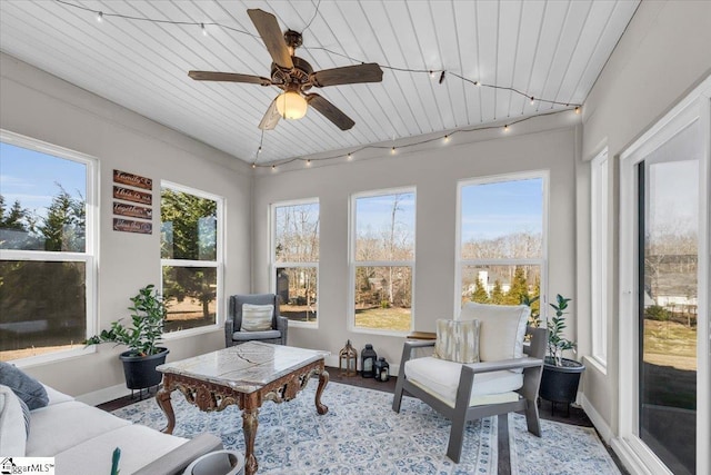 sunroom with rail lighting and ceiling fan