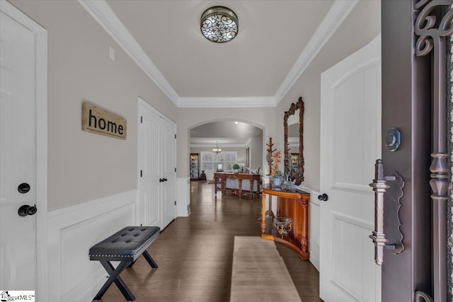 entryway with dark hardwood / wood-style flooring and crown molding