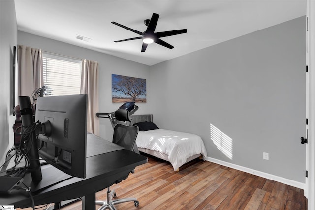 bedroom with hardwood / wood-style floors and ceiling fan