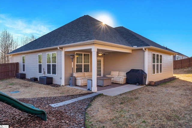 back of house with ceiling fan and a patio area