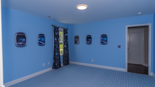 unfurnished bedroom with dark carpet