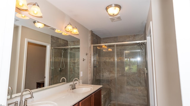 bathroom featuring vanity and an enclosed shower