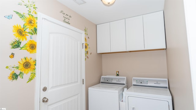 laundry room with cabinets and washer and clothes dryer