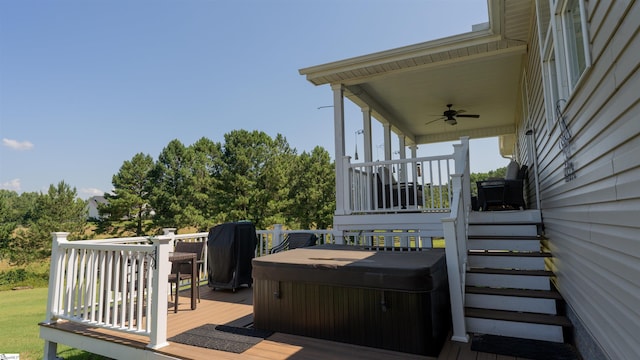 wooden deck featuring a hot tub and ceiling fan