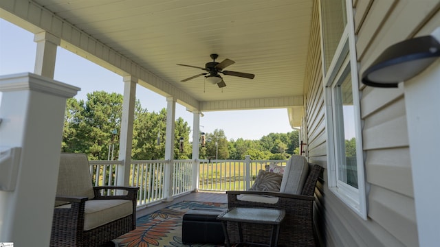 sunroom / solarium featuring ceiling fan