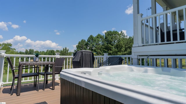 wooden deck featuring a hot tub