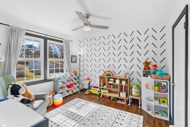 game room featuring dark hardwood / wood-style floors and ceiling fan