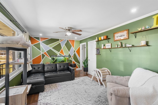 living room featuring hardwood / wood-style floors, crown molding, and ceiling fan