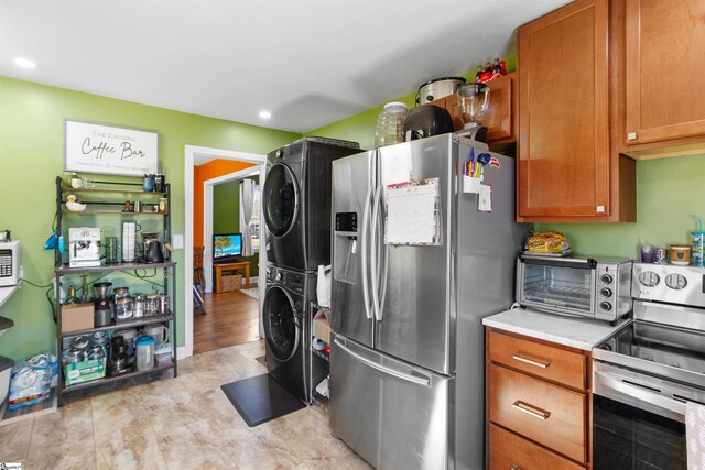 kitchen featuring appliances with stainless steel finishes and stacked washer / drying machine