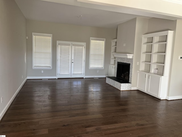 unfurnished living room featuring dark hardwood / wood-style floors