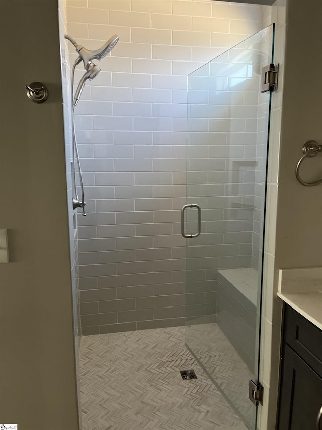 bathroom with an enclosed shower and vanity