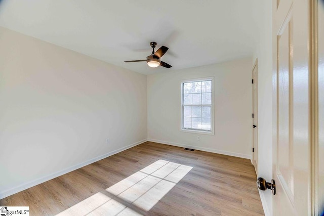 empty room with light hardwood / wood-style flooring and ceiling fan