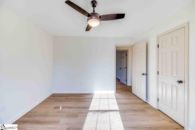 spare room with light hardwood / wood-style floors and ceiling fan